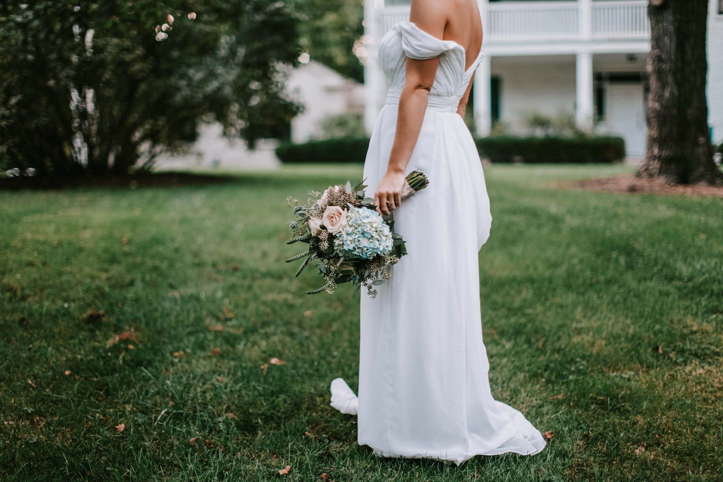 A Bride in an Off-Shoulder Wedding Dresses on the Grass