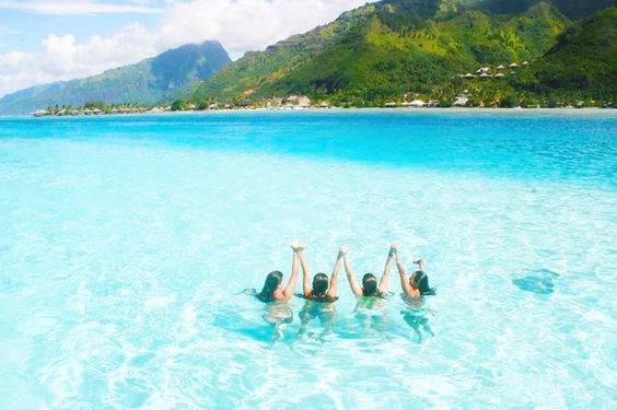 Four Girls Swimming in Blue Water