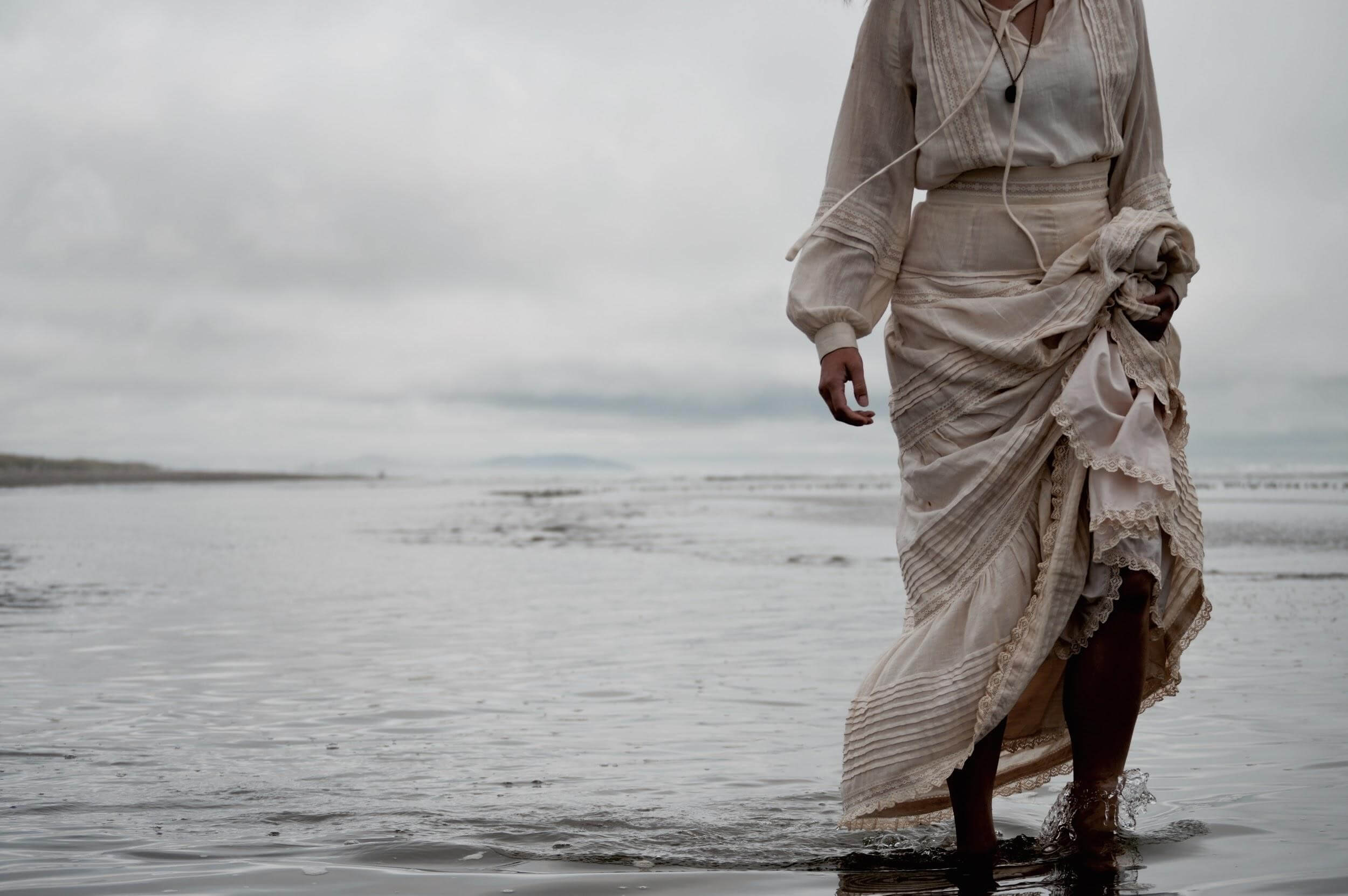 A woman wears maxi dress on the beach