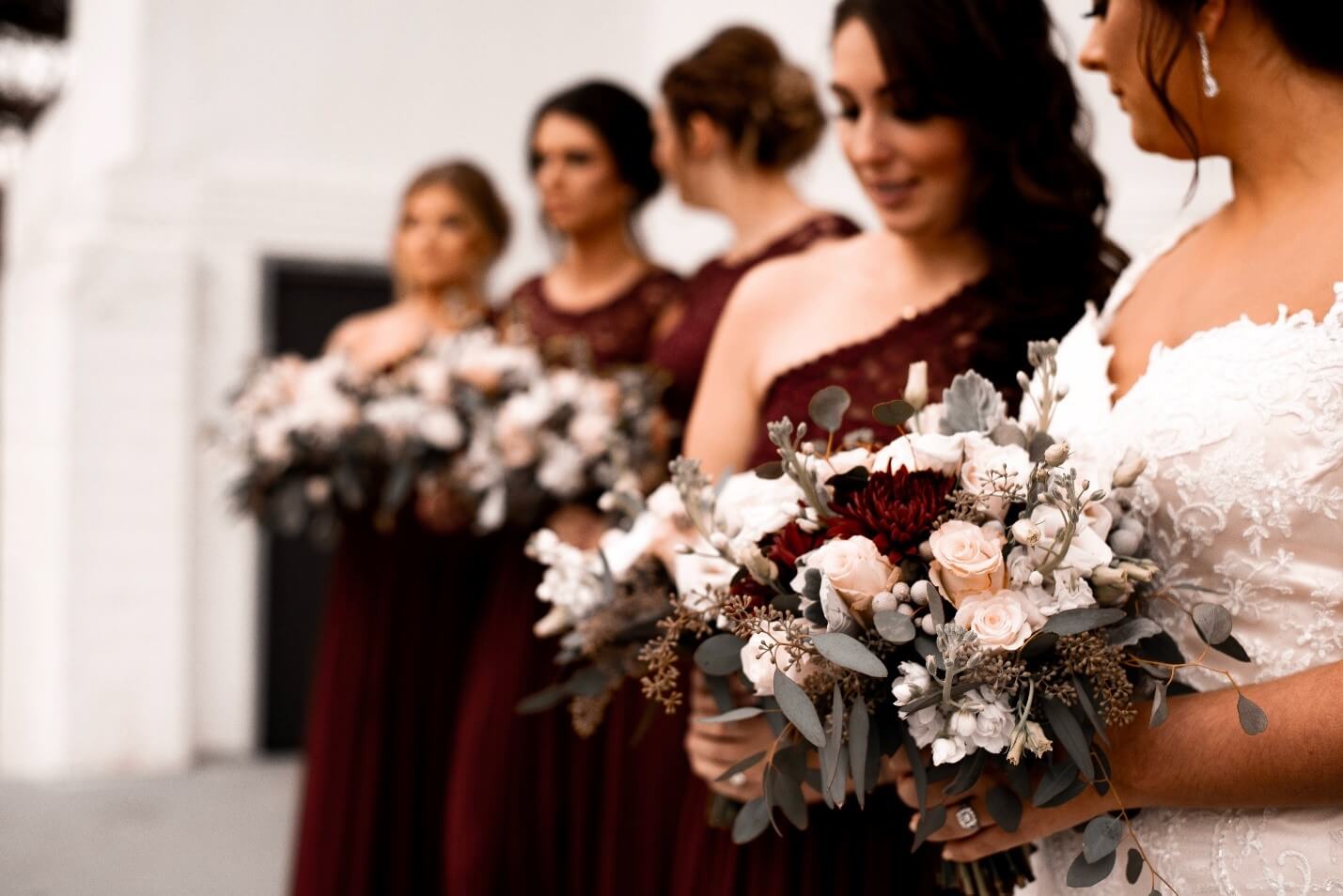 Bridesmaids dressed up at the wedding, holding bouquets