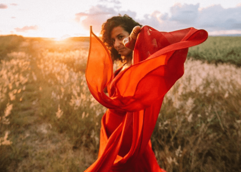 Girl in a red dress in a field