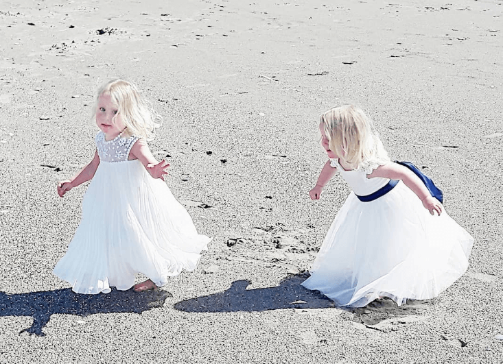 Lovely flower girls catching on the beach